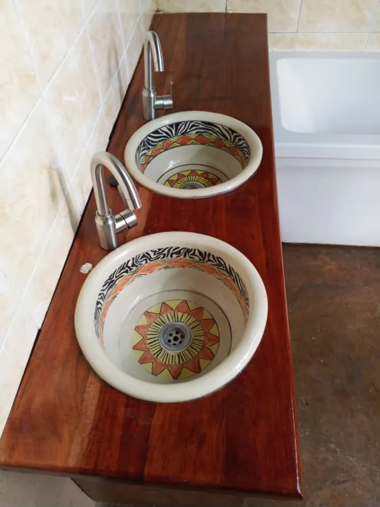 Two hand-painted basins set into a timber counter