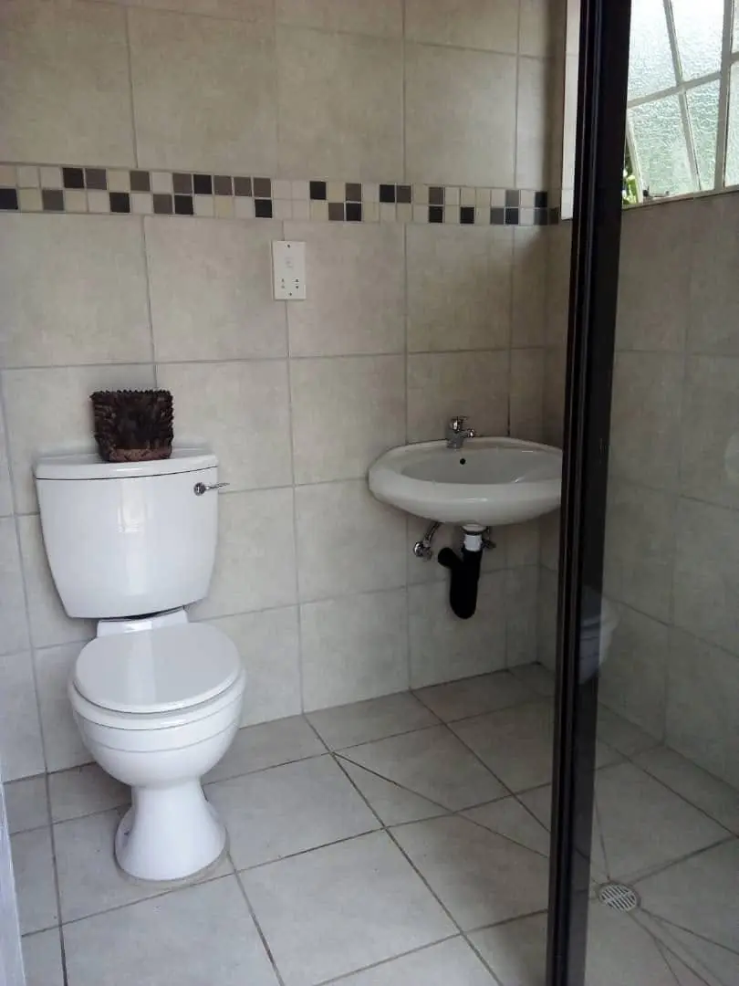 Clean tiled toilet and basin