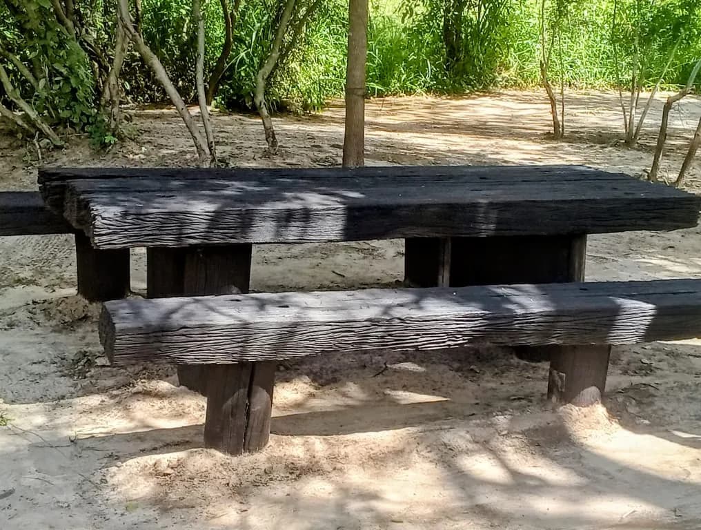 Heavy timber table and benches on the white sand