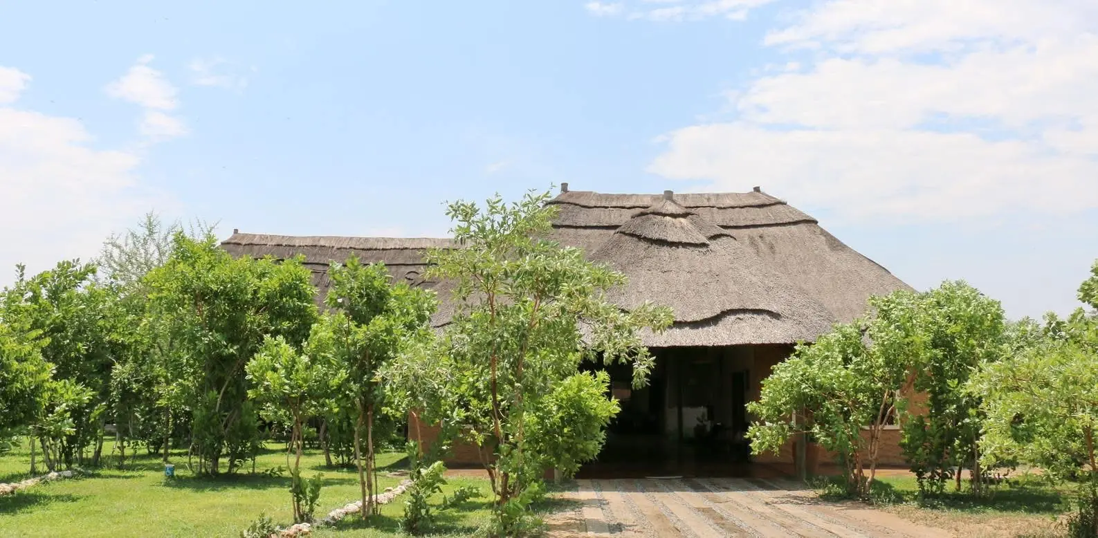 Thatched main building from the garden path