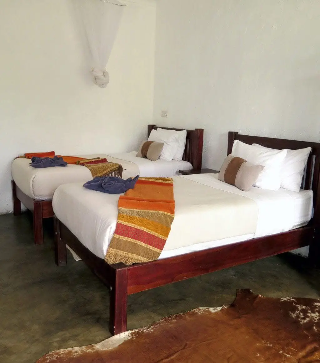 Twin room with grey and orange bedding