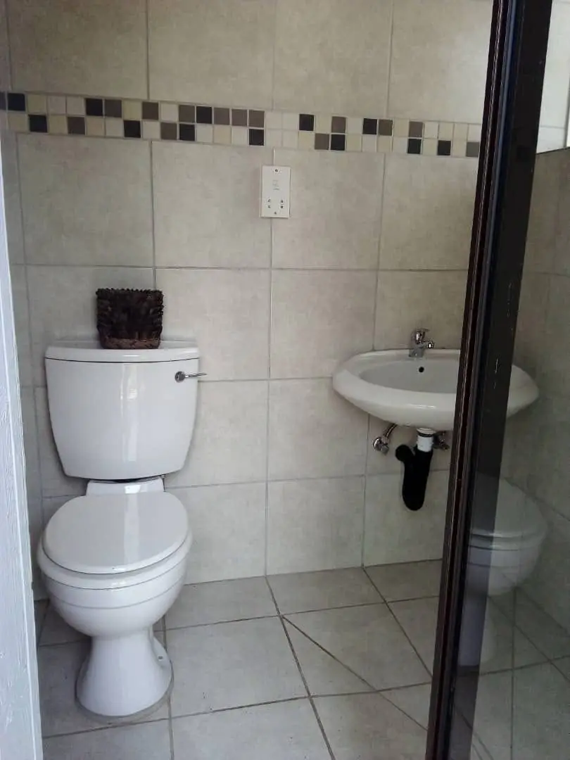 Tiled en-suite toilet and basin